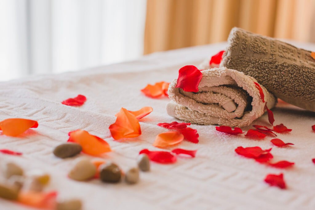 Massage in Jumeirah: treatment room at Zuri Beauty Lounge with fresh towels and rose petals
